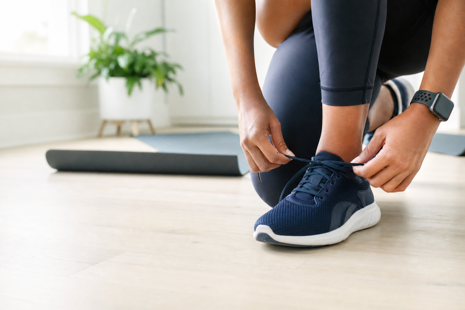 Person tying running shoes before workout